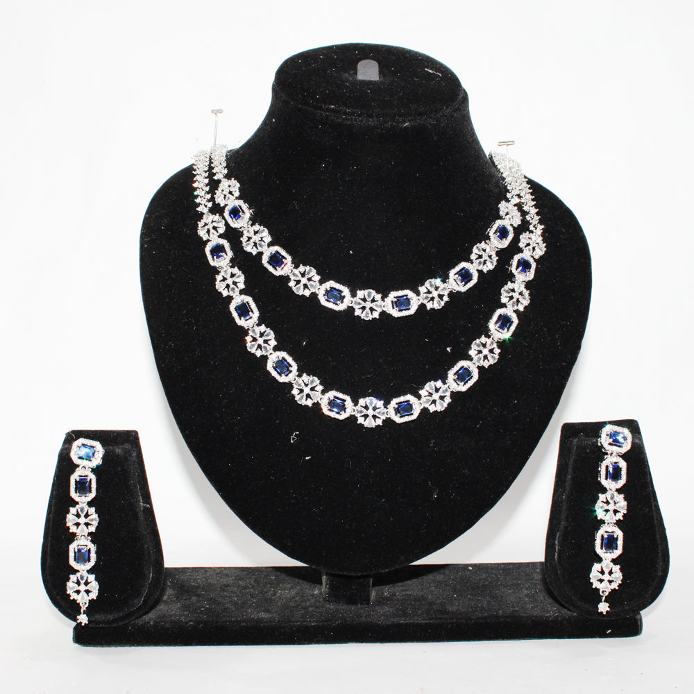Jewelry set with necklace, earrings, and bracelet on a black stand against a white background
