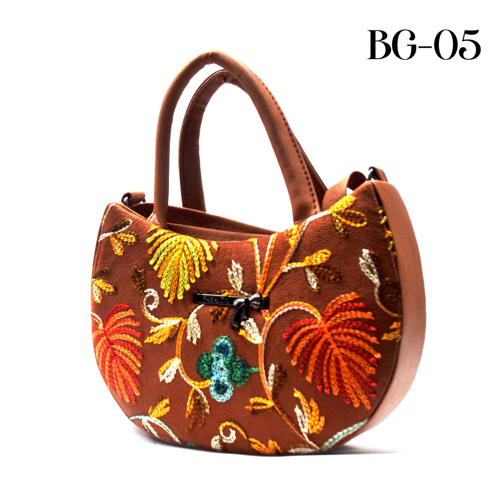 Brown handbag with colorful floral embroidery on a white background