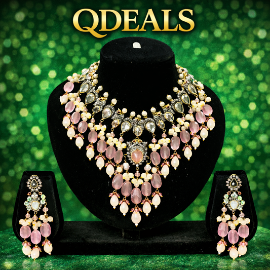 Jewelry set with necklace and earrings on a black stand against a green bokeh background, featuring the brand 'QDEALS'.