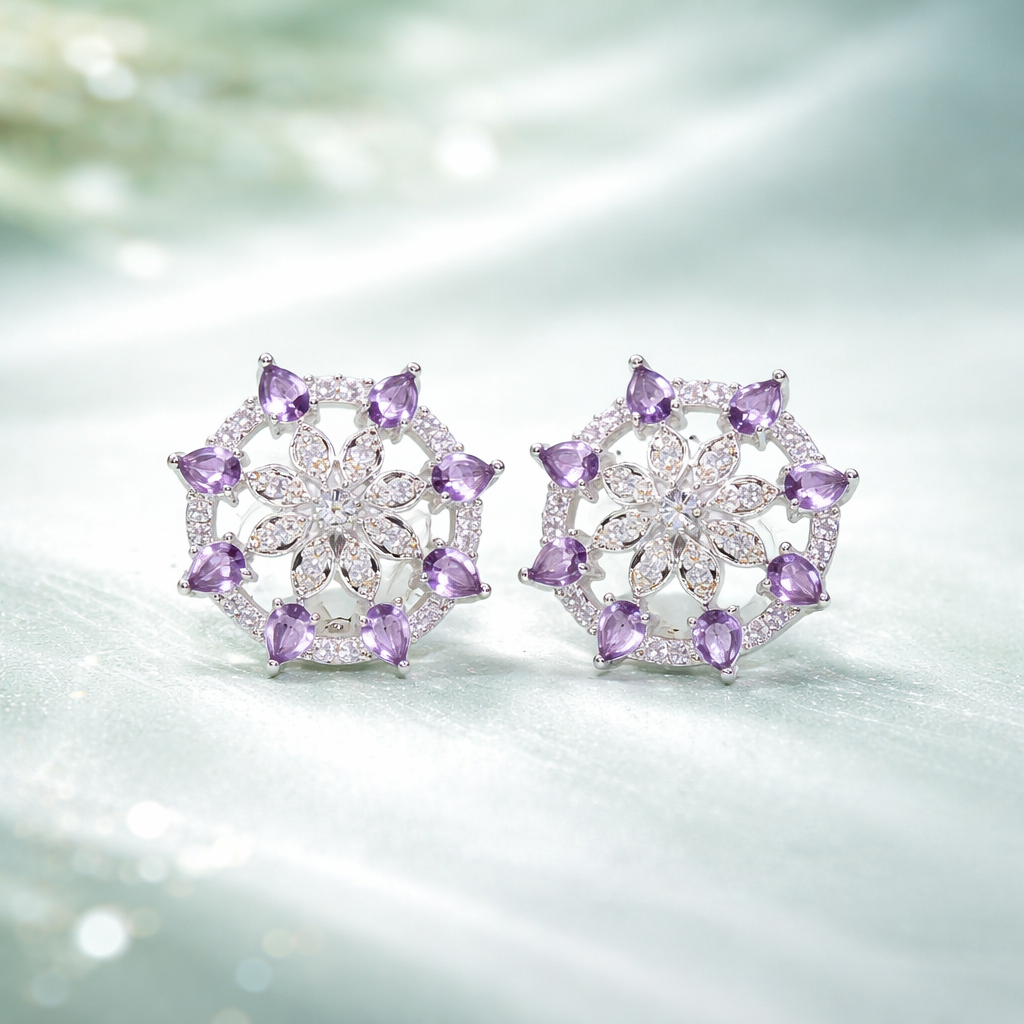 Pair of silver earrings with purple gemstones on a soft, blurred background