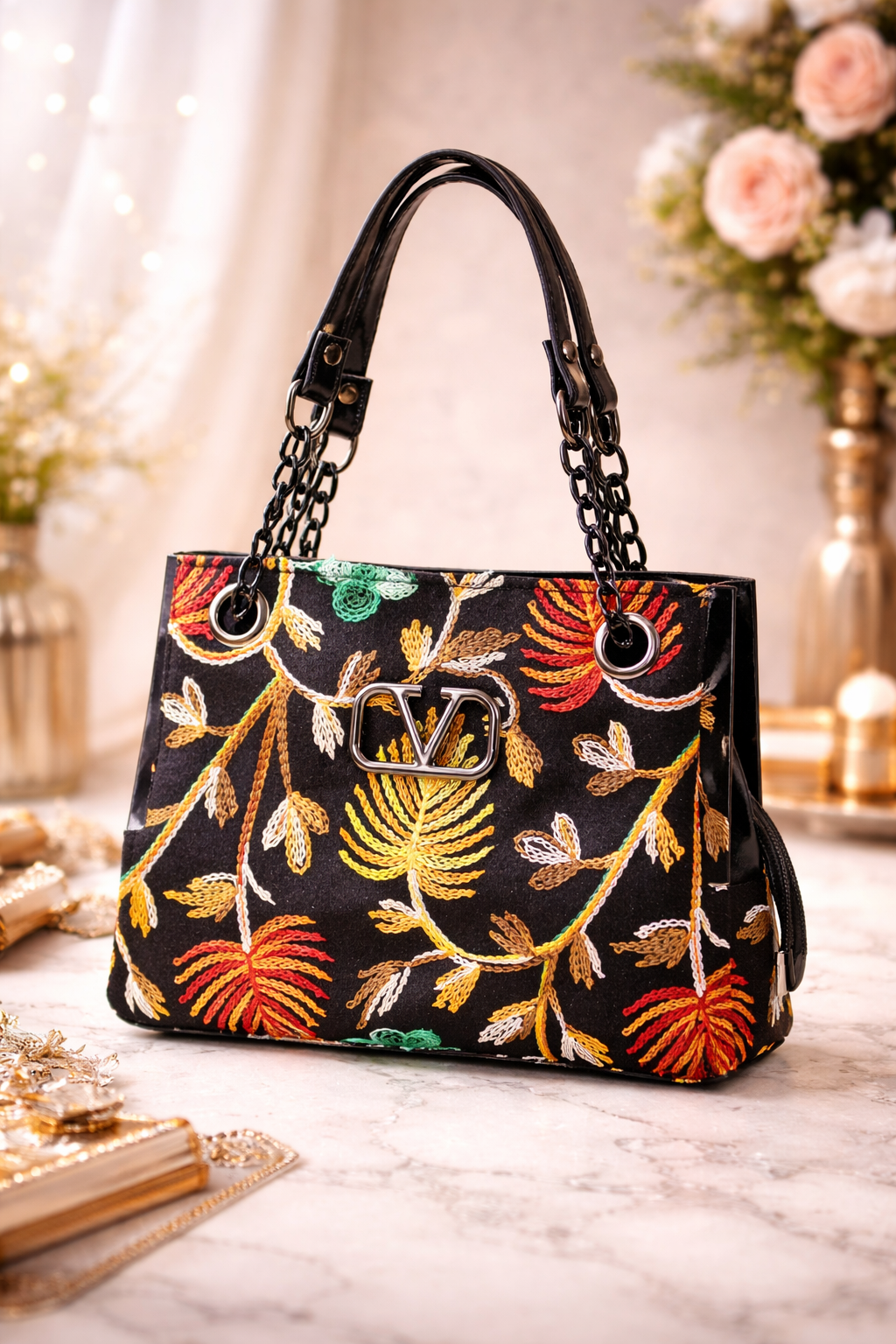 Handbag with floral embroidery on a marble surface with decorative background