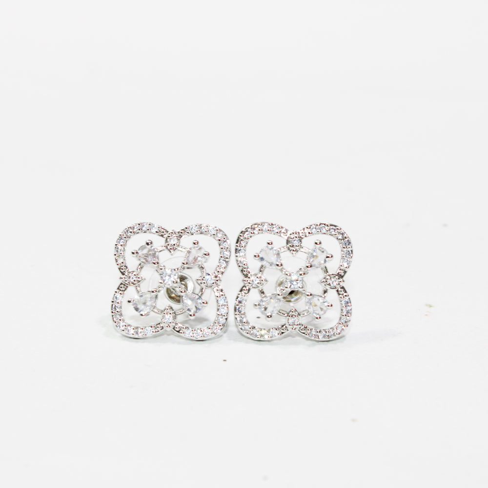 Pair of silver floral earrings on a white background