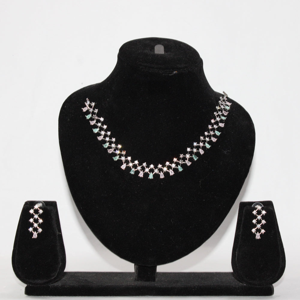 Jewelry set with necklace and earrings on a black stand against a white background