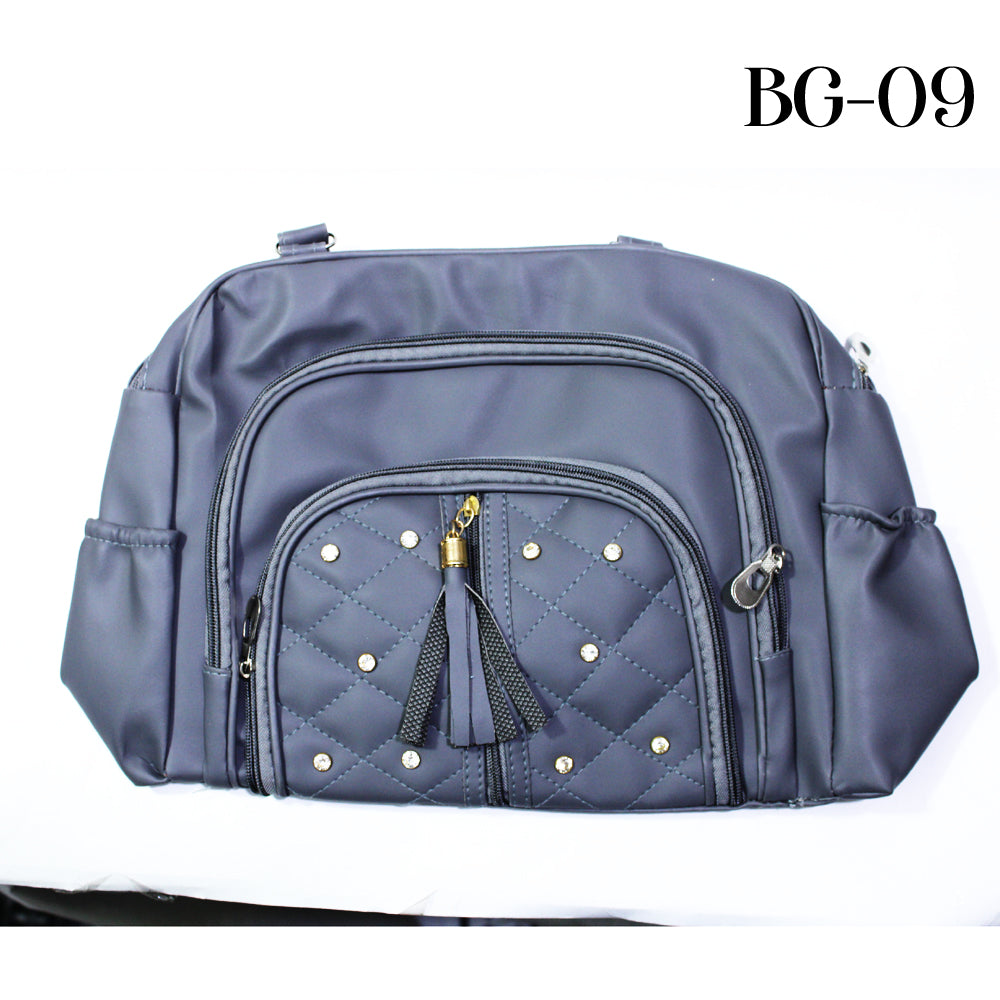 Blue quilted bag with decorative studs and a tassel on a white background