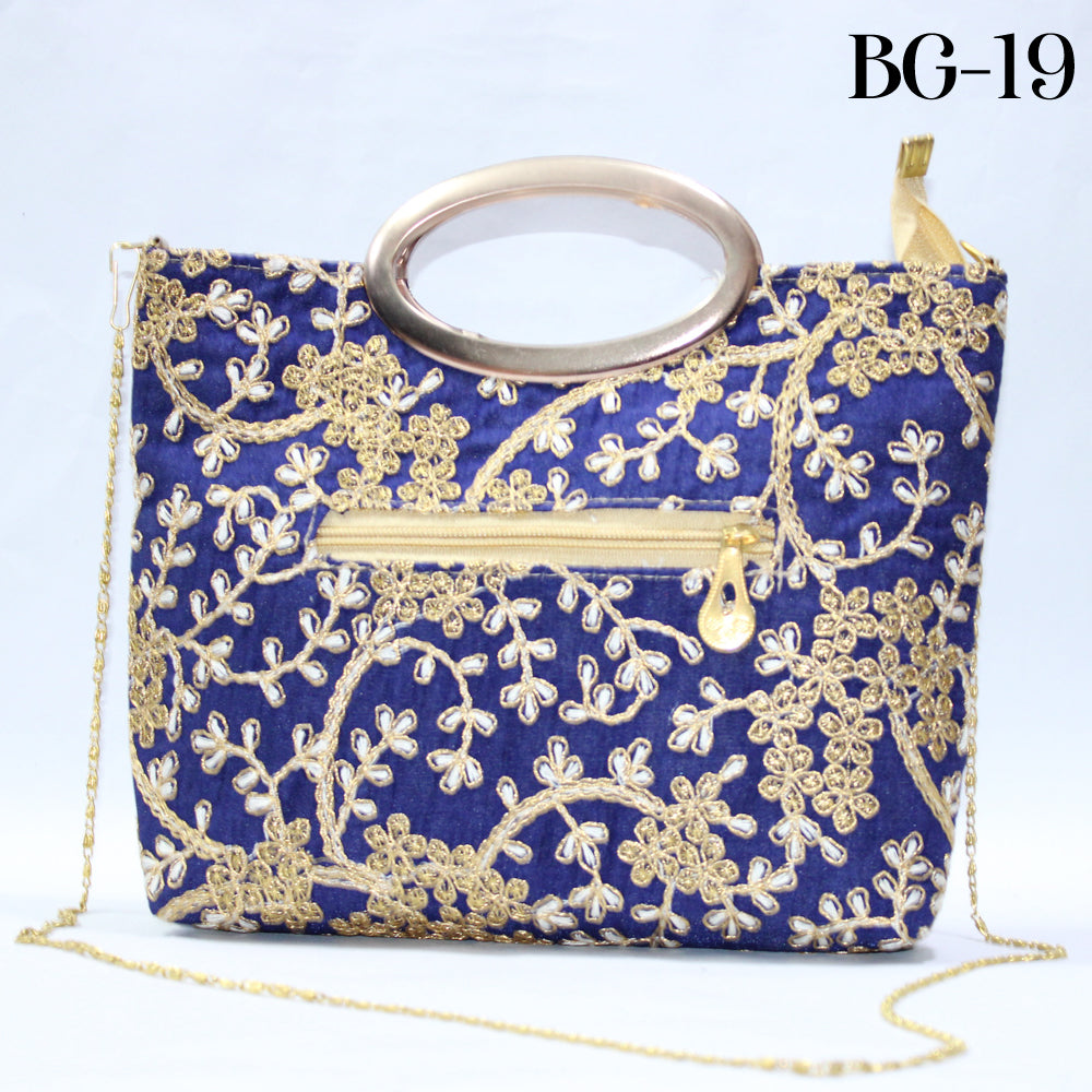 Blue handbag with gold embroidery and chain strap on a light blue background
