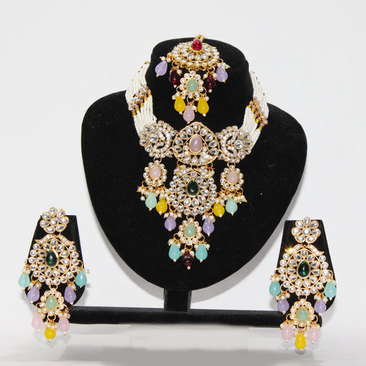 Jewelry set with necklace and earrings on a black stand against a white background