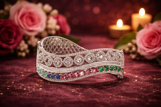 Elegant tiara with gemstones on a dark surface with flowers and candles in the background