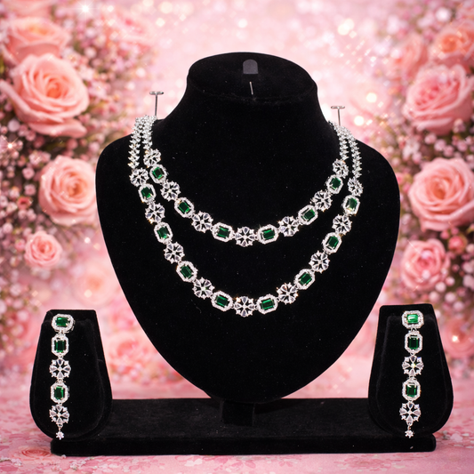 Jewelry set with necklace and earrings on a black stand against a floral background