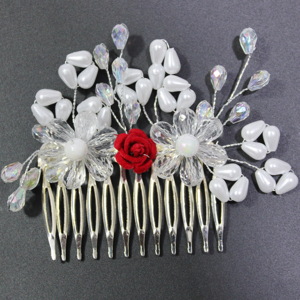 Hair comb with floral and red rose design on a dark background