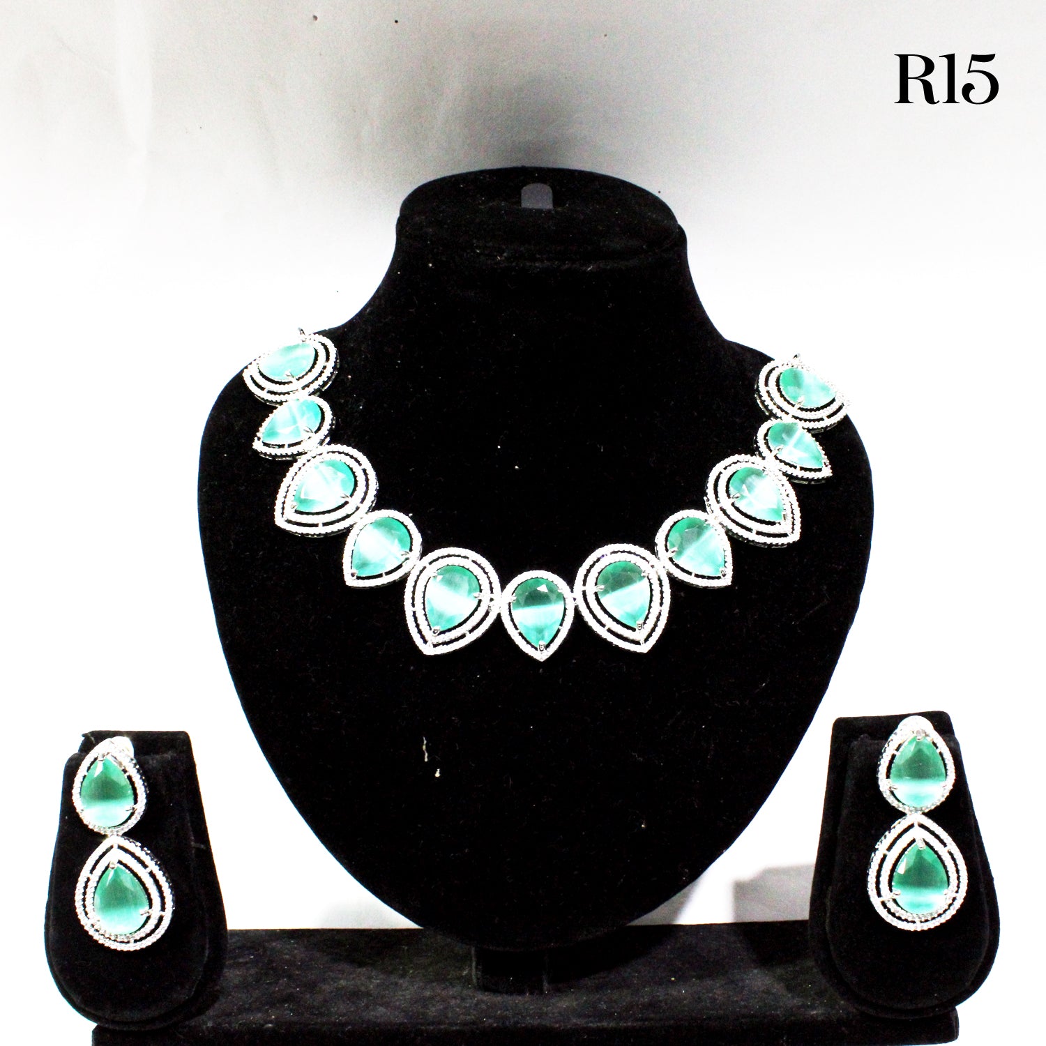 Jewelry set with necklace and earrings on a black stand