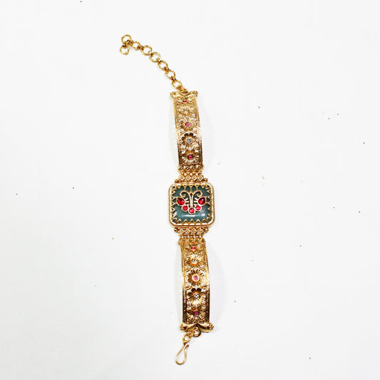 Decorative gold bracelet with gemstones on a white background