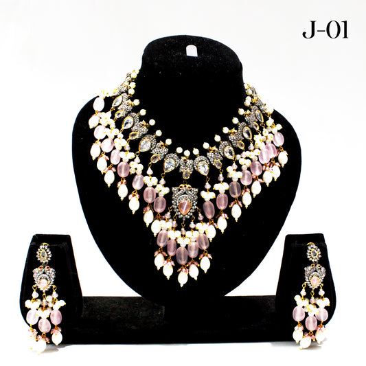 Jewelry set with necklace and earrings on a black stand against a white background