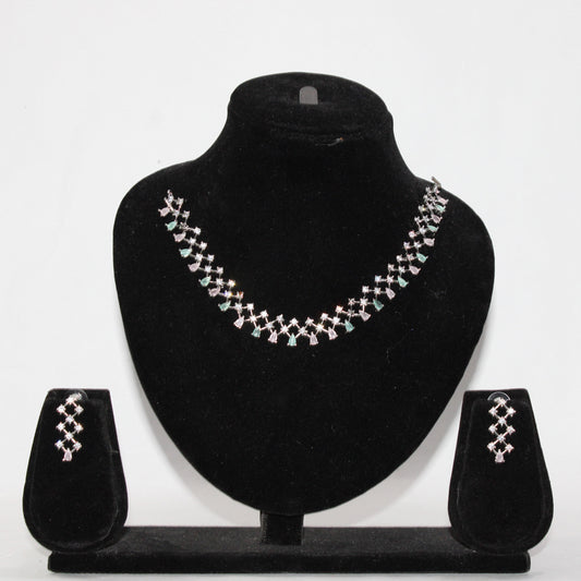 Jewelry set with necklace and earrings on a black stand against a white background